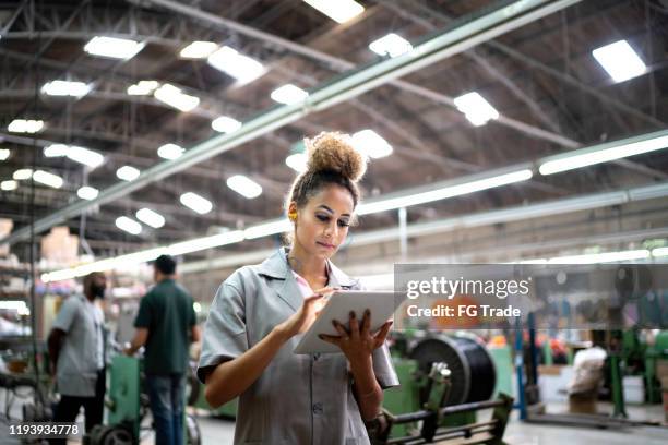 woman using digital tablet in the industry - metallurgy stock pictures, royalty-free photos & images