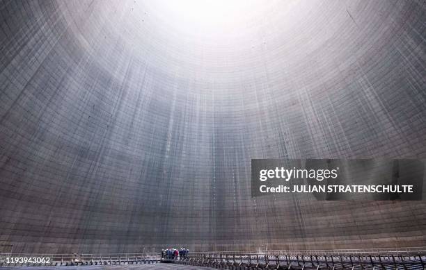 Picture taken on January 16, 2020 shows a group visiting the inside of a cooling tower at Mehrum coal-fired power plant in Hohenhameln, Germany. /...