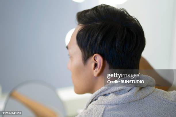 young man styling hair - man combing hair stock pictures, royalty-free photos & images