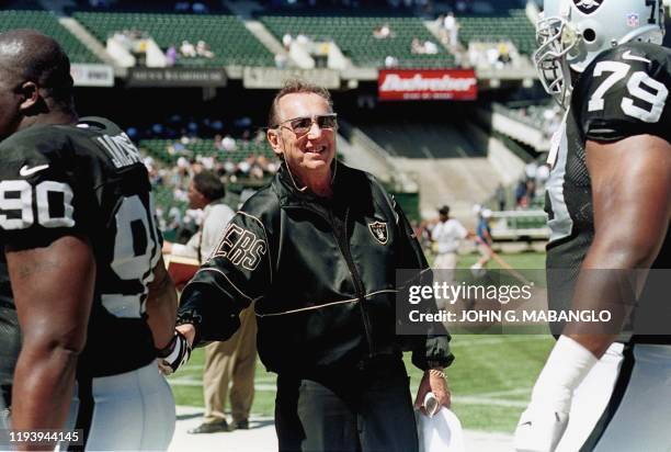 Oakland Raiders owner Al Davis greets his players Grady Jackson and Mo Collins before their pre-season game against the Dallas Cowboys 15 August in...