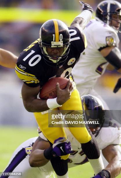 Quarterback Kordell Stewart of the Pittsburgh Steelers tries to escape the grasp of Ray Lewis of the Baltimore Ravens in first quarter during AFC...