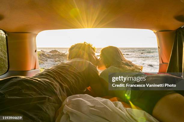 couple kissing in a van, new zealand. - new zealand holiday stock pictures, royalty-free photos & images