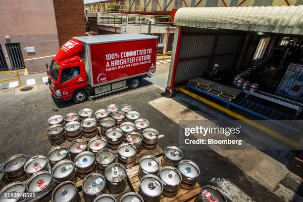 Branded electric Mitsubishi Fuso Truck & Bus Corp. Truck drives through the yard during the launch of AB InBev Africa's renewable energy programme at...