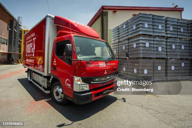 Branded electric Mitsubishi Fuso Truck & Bus Corp. Truck drives through the yard during the launch of AB InBev Africa's renewable energy programme at...