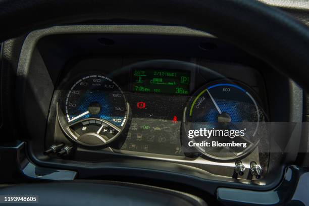 Battery charge information is displayed on the dashboard inside the cab of an electric Mitsubishi Fuso Truck & Bus Corp. Truck during the launch of...