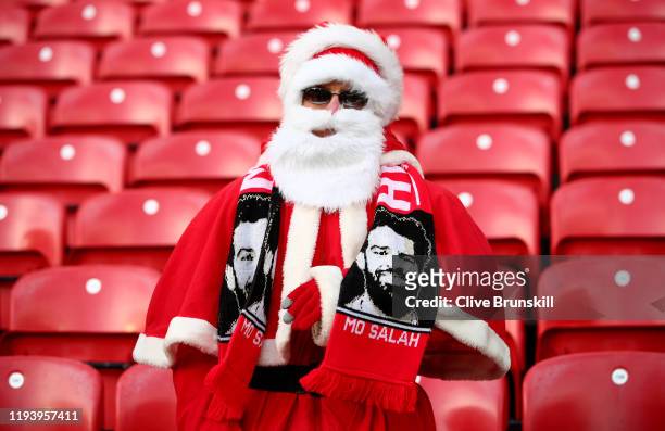 Liverpool fan dressed as father Christmas with a Mohammed Salah scarf prior to the Premier League match between Liverpool FC and Watford FC at...