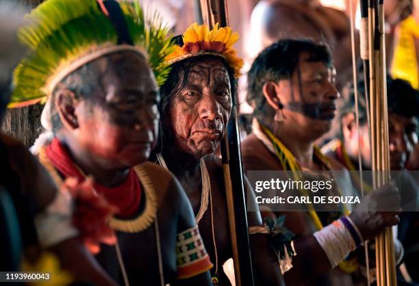 Indigenous tribesmen listen to a speech by Indigenous leader Cacique Raoni of Kayapo tribe, in Piaracu village, near Sao Jose do Xingu, Mato Grosso...