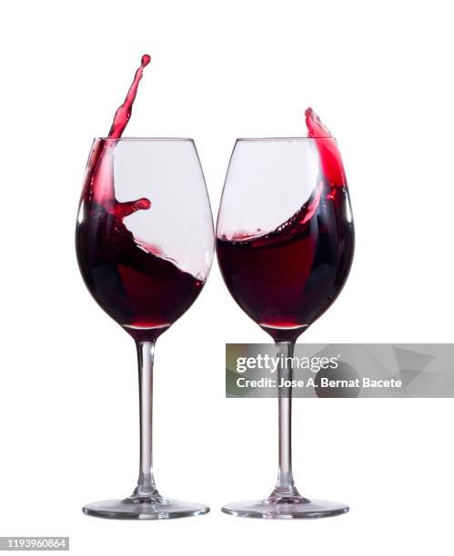 raising a toast of red wines on a white background. - champagner gläser mit flasche unscharfer hintergrund stock-fotos und bilder