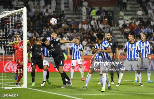 Baghdad Bounedjah of Al-Sadd Sports Club jumps for the ball with Nicolas Sanchez of C.F. Monterrey during the FIFA Club World Cup 2nd round match...