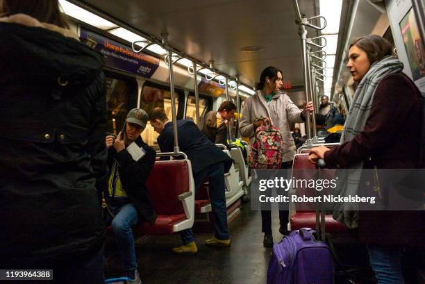 Passengers ride the Metro subway in Washington, DC, December 12, 2019. The Washington Metro opened in 1976 and carries approximately 800,000...