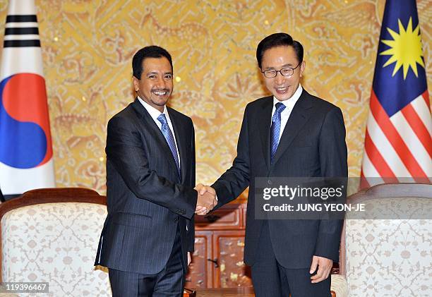 South Korean President Lee Myung-Bak shakes hands with Malaysian King Mizan Zainal Abidin during their meeting at the presidential Blue House in...