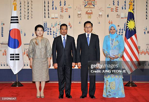 South Korean President Lee Myung-Bak and First Lady Kim Yoon-Ok pose with Malaysian King Mizan Zainal Abidin and Queen Tuanku Nur Zahirah before...