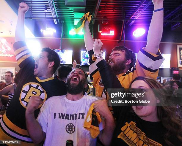 From left, Paul Rogers, Bob Kennedy, Jeff Fox, and Sherie Schuettner celebrate Wednesday at Buffalo Wild Wings in Saugus, Mass., after the Boston...