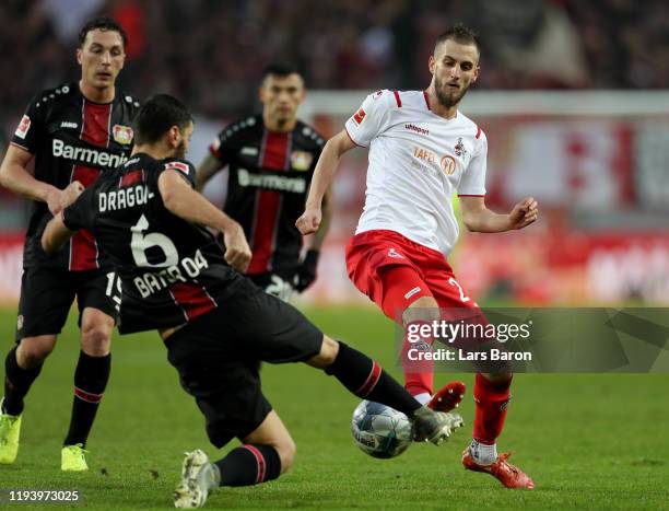 Aleksandar Dragovic of Bayer Leverkusen challenges Dominick Drexler of Koeln during the Bundesliga match between 1. FC Koeln and Bayer 04 Leverkusen...