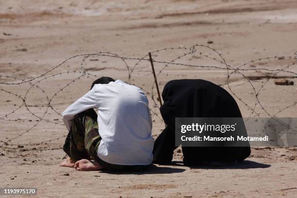 iranian muslim couple are praying in nature - palestinian fotografías e imágenes de stock