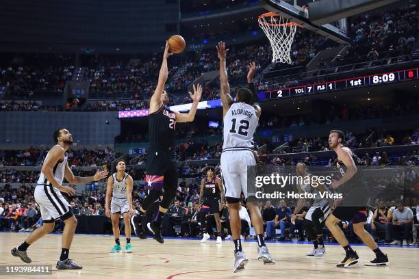 Dario Saric of the Phoenix Suns shoots the ball against LaMarcus Aldrige of the San Antonio Spurs during a game between San Antonio Spurs and Phoenix...