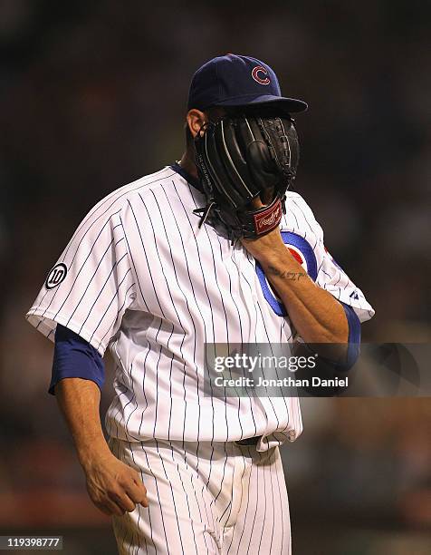 Starting pitcher Matt Garza of the Chicago Cubs yells into his glove after being taken out of a game against the Philadelphia Phillies at Wrigley...