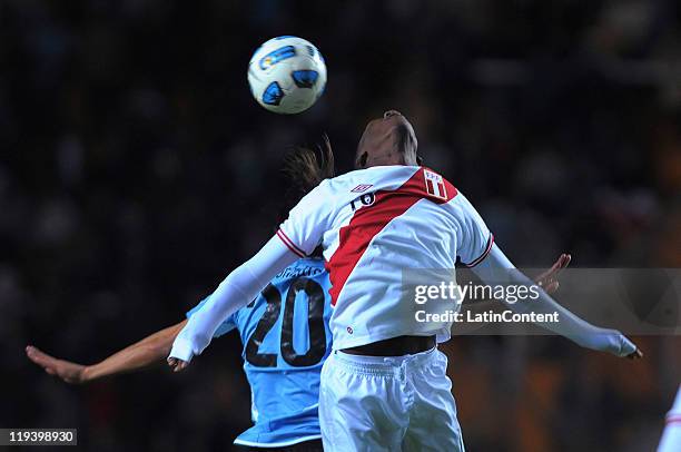 Luis Advíncula of Peru struggles for the ball with Álvaro Gonzalez of Uruguay during a match as part of Semi Final of 2011 Copa America at Ciudad de...