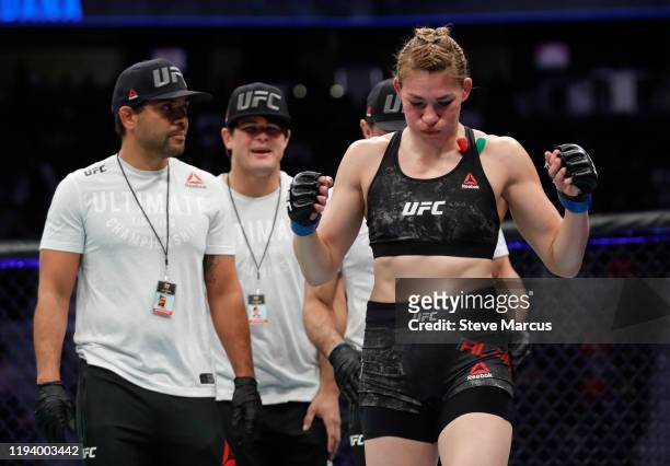 Irene Aldana leaves the Octagon with members of her team after defeating Ketlen Vieira in a bantamweight fight during UFC 245 at T-Mobile Arena on...