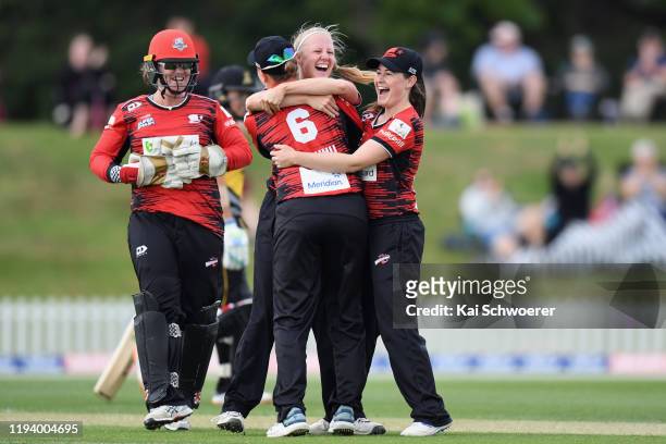 Gabby Sullivan of the Magicians is congratulated by team mates after achieving a hat-trick by dismissing Thamsyn Newton of the Blaze during the...