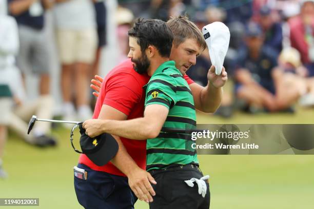 Bryson DeChambeau of the United States team shakes hands with Adam Hadwin of Canada and the International team after they halved their match on the...