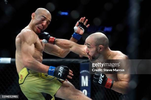 Marlon Moraes connects with a punch on Jose Aldo in their bantamweight fight during UFC 245 at T-Mobile Arena on December 14, 2019 in Las Vegas,...