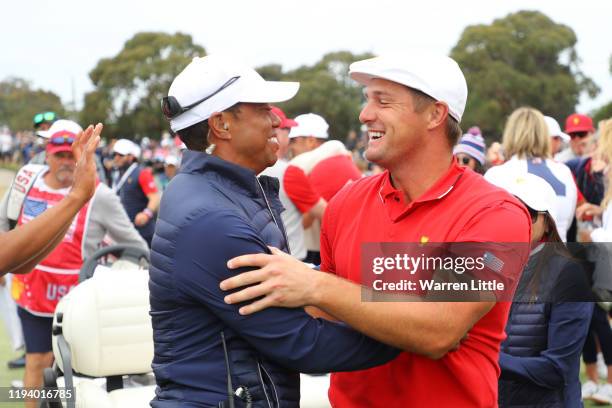 Playing Captain Tiger Woods of the United States team and Bryson DeChambeau of the United States team celebrate winning the Presidents Cup during...