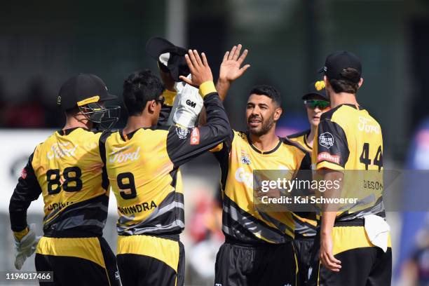 Jeetan Patel of the Firebirds is congratulated by team mates after dismissing Henry Shipley of the Kings during the T20 Super Smash match between the...
