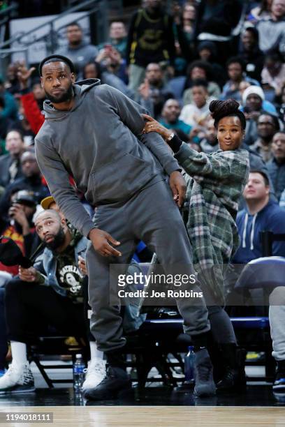 LeBron James of the Los Angeles Lakers and wife Savannah James react while watching Sierra Canyon High School during the Ohio Scholastic Play-By-Play...
