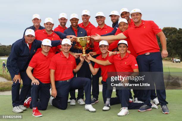 The United States team celebrates with the trophy after they won the Presidents Cup 16-14 during Sunday Singles matches 1on day four of the 2019...