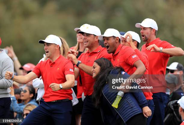 United States team players celebrate Justin Thomas, Gary Woodland, Tony Finau, and Webb Simpson as they watch Matt Kuchar seal the crucial point on...