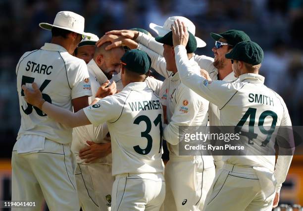 Nathan Lyon of Australia celebrates after taking the wicket of Tom Latham of New Zealand during day four of the First Test match in the series...