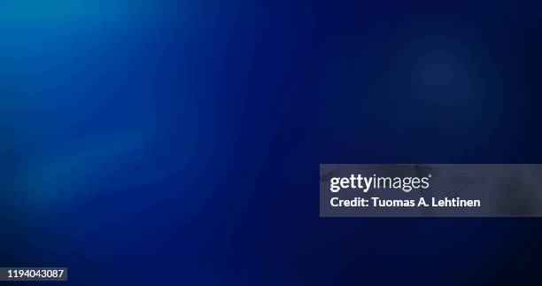 abstract image of curvy, blurred and soft lines or layers on blue background. rippled effect, copy space. dci 4k resolution. - blue background photos et images de collection