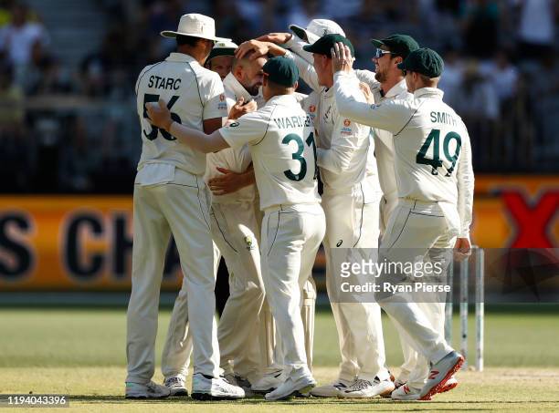 Nathan Lyon of Australia celebrates after taking the wicket of Tom Latham of New Zealand during day four of the First Test match in the series...