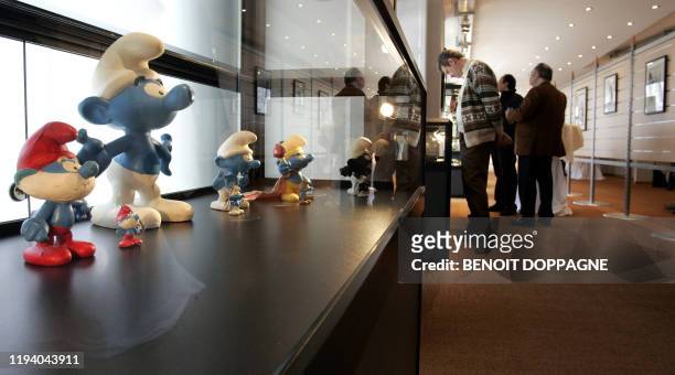 Picture of visitors looking at exhibits near the "smurfs" 01 March 2006 inside the newly opened "Maison de la Bande Dessinee" in Brussels.