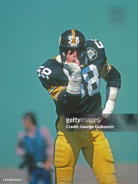 Linebacker Jack Lambert of the Pittsburgh Steelers indicates the distance the Cincinnati Bengals need to move the football for a first down during a...