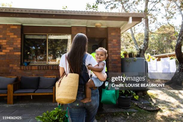 young family reunites after work and school - over burdened stock pictures, royalty-free photos & images