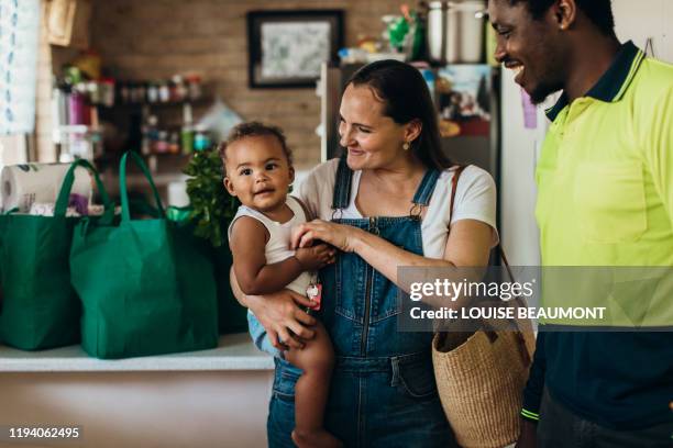 young australian mixed race couple and son - sustainable lifestyle photos stock pictures, royalty-free photos & images