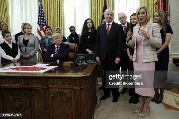 Pastor Paula White, right, speaks while U.S. President Donald Trump, center left, listens during a meeting to announce new guidance on prayer in...