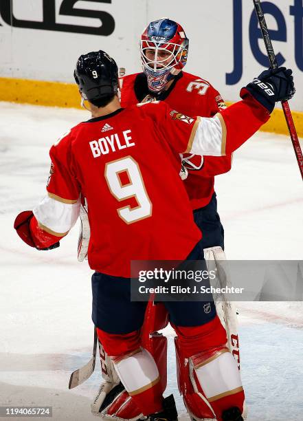 Goaltender Sam Montembeault of the Florida Panthers celebrates with teammate Brian Boyle their 4-3 win over the Los Angeles Kings at the BB&T Center...