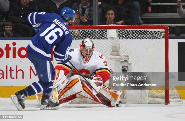 David Rittich of the Calgary Flames makes the game winning stop against Mitchell Marner of the Toronto Maple Leafs during an NHL game at Scotiabank...
