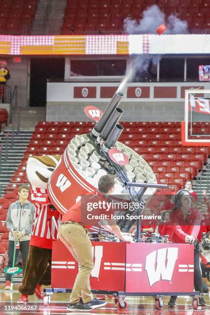 Wisconsin mascot Bucky Badger shoots tee shirts into the crowd during a college basketball game between the University of Wisconsin Badgers and the...