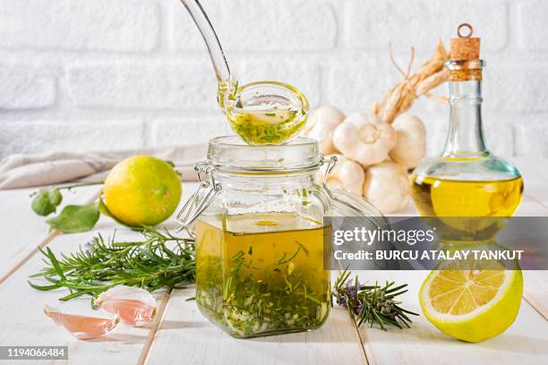 fresh homemade salad dressing with rosemary, lemon and garlic - dressing up stock-fotos und bilder