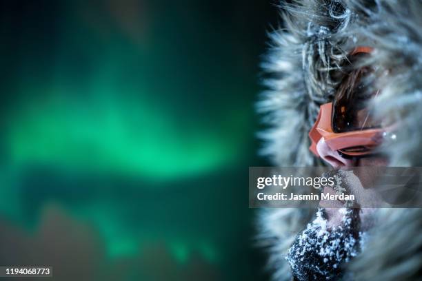 portrait male winter adventurer looking at northern lights - arctic explorer stock pictures, royalty-free photos & images