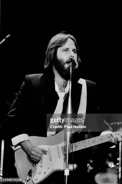 American Rock and Pop musician Carl Wilson plays guitar as he performs onstage at the Park West, Chicago, Illinois, April 5, 1981.