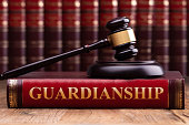 Gavel And Striking Block Over Guardianship Law Book