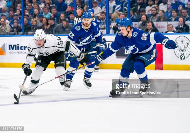 Los Angeles Kings left wing Austin Wagner reaches for the puck as Tampa Bay Lightning defenseman Mikhail Sergachev defends during the NHL Hockey...