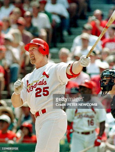St. Louis Cardinals first baseman Mark McGwire watches his league leading 30th home run against the Houston Astros in the first inning 01 July 2000...
