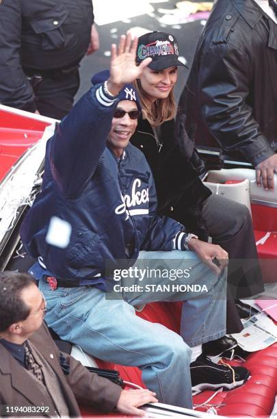 New York Yankees' Darryl Strawberry , who sat out the post-season after undergoing colon cancer surgery, rides up Broadway in New York City with his...