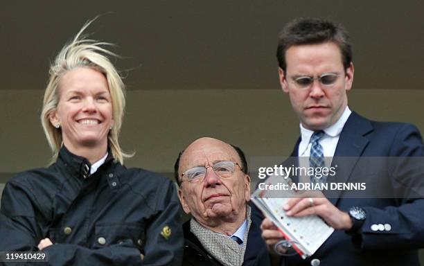 Media mogul Rupert Murdoch stands behind his children James Murdoch and Elisabeth Murdoch overlooking the racing during the third day of horse racing...